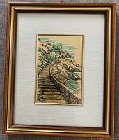 Silk print of stairway beside water in frame