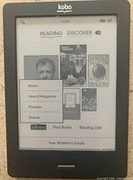 Front view of powered-on Kobo eReader displaying home screen