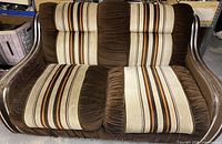 Front view of brown velour loveseat with striped panels