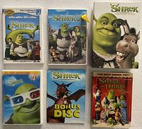 Six DVD sleeves visible: Shrek, Shrek 2, Story So Far slip, Shrek bonus disc, extra adventure sleeve, Shrek the Third