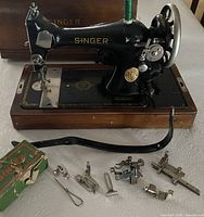 Singer 99K on wood base with attachments spread in front