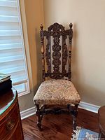 Full view of carved hall chair positioned in corner