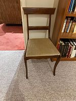 Front view of entire chair showing frame, back slats, seat, and legs