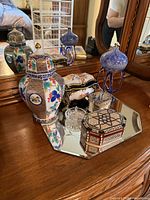 All items on mirrored tray: porcelain ginger jar, boxes, art glass, crystal dishes, tray