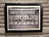 Full view of framed photograph on brick wall