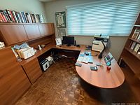 Full view of L-shaped desk showing hutch, drawer pedestals, curved peninsula