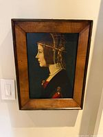 Framed reproduction print hung on wall, full view