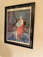 Framed Vogue cover print hanging on wall
