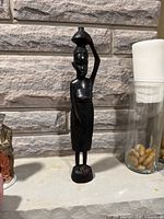 Front view of the wooden female figure sculpture