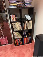 Front view of black 8-cube Kallax shelf with contents present for scale