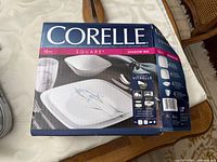 Box front showing Corelle Square Shadow Iris branding and plate image