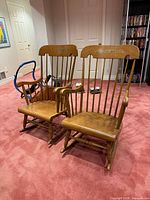 Both wooden rocking chairs front view, showing design and condition
