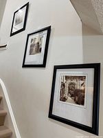 All three framed photographs hung on wall, showing relative sizes and frames