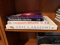 Stack showing spines of all three books on shelf