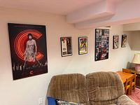 Wall with one large Chicago poster and four small framed posters