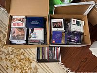 Two large boxes and one smaller box filled with assorted CDs