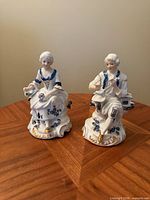 Front view of both porcelain figurines