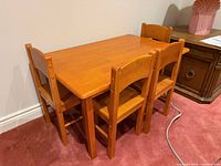 Front angle of table with four chairs