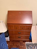 Front view of closed secretary desk showing full structure and hardware