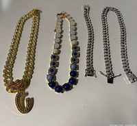 Overview of four jewelry pieces laid out on surface