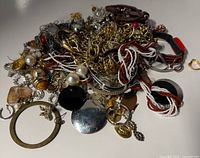 Pile of assorted costume jewelry pieces