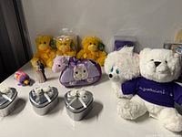 Overview of all plush toys, tins, figurine on tabletop