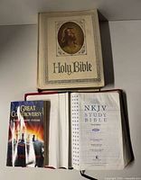 Three books laid out: Holy Bible, NKJV Study Bible open, The Great Controversy