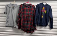 Overall view of three shirts hanging