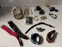 Overview showing cuff bangles, faux-croc straps, jewellery pieces, fidget spinner, adapters