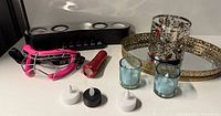 Overview of lot showing speaker, goggles, flashlight, candles, votives and tray