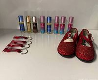 Lot overview showing shoes, perfume bottles, keychain openers