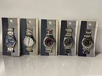 Five packaged Greenwich wristwatches lined up