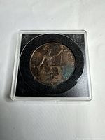 Coin reverse (Britannia) within holder