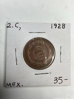 Obverse of 1928 2 Centavos coin in cardboard holder