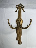 Full view of brass twin-arm ribbon & tassel wall hook