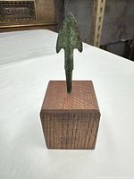 Front view of spearhead mounted on wood block