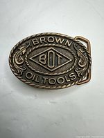 Front view showing “BROWN OIL TOOLS BOT” design and patina