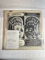 Back cover of LP in protective sleeve with info slip visible