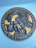 Full view of round carved wooden plaque