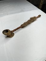 Full view of the pipe showing wood bowl, leather wrapping and fur section