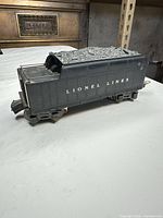 Left side view of Lionel Lines black tender showing lettering and trucks