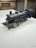 Left front side view of Lionel black metal steam locomotive