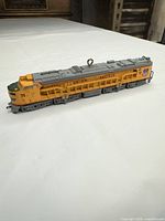 Side view of yellow Union Pacific locomotive ornament showing number 71 and roof eyelet