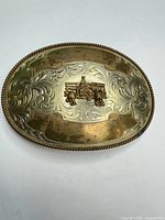 Front view of nickel-plated oval buckle showing overall design and wear