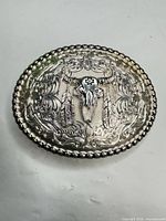 Front view showing steer skull, feathers, scroll engraving, beaded border