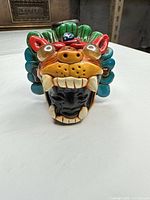 Front view showing jaguar face, teeth and multicolor crest