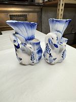 front view of both swan vases showing decoration and form