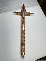 front view of entire wooden cross with metal and stone details