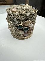 angled view showing side filigree pattern and cabochon stones