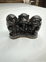 Front view of cast iron three wise monkeys figurine